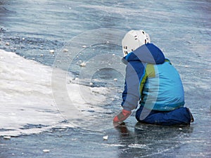 Child playing on frozen lake