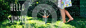 Child playing with garden sprinkler. Girl running, jumping. Lifestyle, authentic concept. Banner