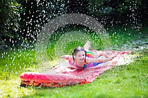 Child playing with garden water slide