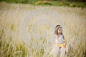 Child playing guitar to meadow outdoor in nature