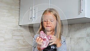 Child playing hand made toy called slime.