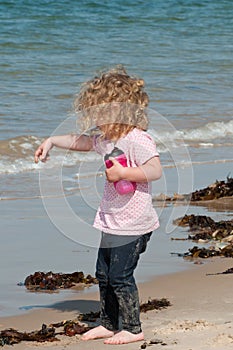 Child playing happily on the beach