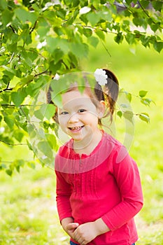 Child playing hide and seek outdoors in park