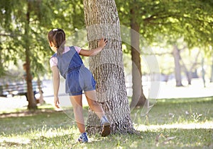 Child Playing Hide And Seek In Park