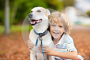 Child playing with his dog. Kids and dogs