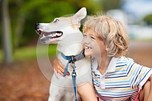 Child playing with his dog. Kids and dogs