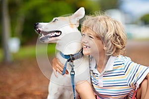 Child playing with his dog. Kids and dogs