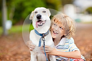 Child playing with his dog. Kids and dogs