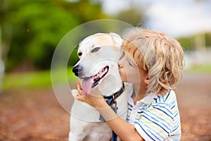 Child playing with his dog. Kids and dogs