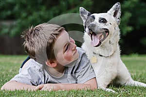 Child playing with his pet dog