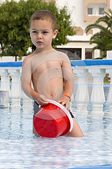 Child playing in hotel swimming pool