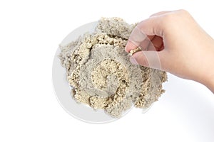 Child playing with kinetic sand. Hand of the child in the sand c