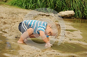 Child playing by lake