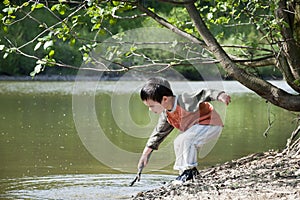 Child playing by the lake