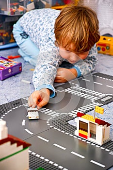 Child playing with Lego in his room
