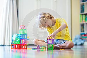 Child playing with magnetic building blocks