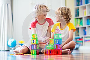 Child playing with magnetic building blocks