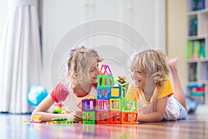 Child playing with magnetic building blocks