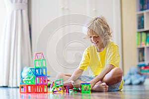 Child playing with magnetic building blocks