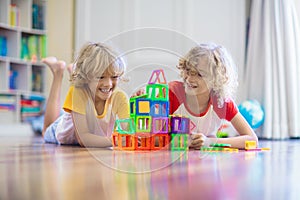 Child playing with magnetic building blocks