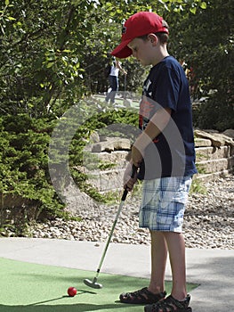 Child Playing Miniature Golf