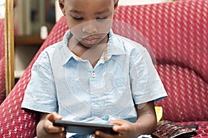 Child playing in the mobile phone.