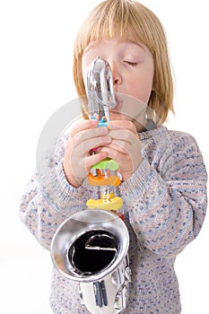 Child playing music on saxophone