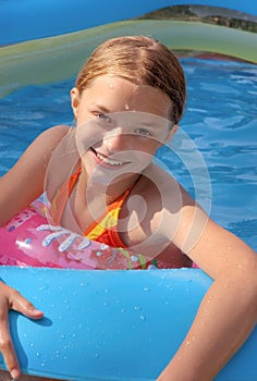 Child playing in paddling pool