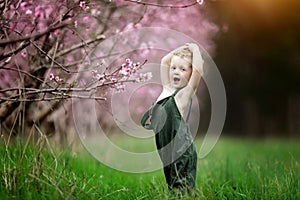 Child playing by peach tree