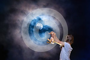 Child playing with pet rabbit at full moon