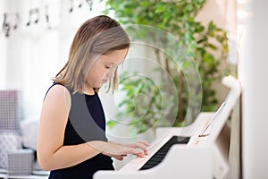 Child playing piano. Kids play music