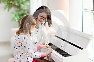 Child playing piano. Kids play music