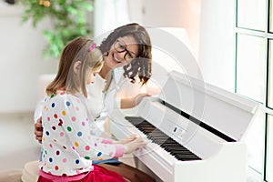 Child playing piano. Kids play music