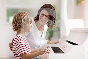 Child playing piano. Kids play music