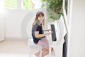 Child playing piano. Kids play music