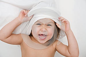 Child playing with pillow, self view point, happy smiling kid, domestic life, authentic kid