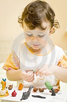 Child playing with plasticine