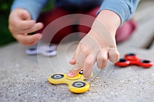 Child playing with popular rotating fidget spinners