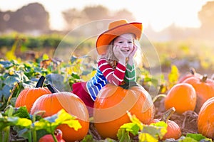 Child playing on pumpkin patch