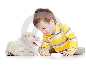 Child playing with puppy dog