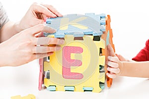 Child playing with puzzle blocks abc alphabet,  isolated
