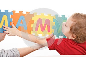 Child playing with puzzle blocks abc alphabet,  object