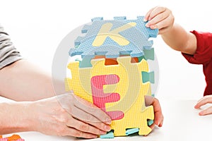 Child playing with puzzle blocks abc alphabet,  school