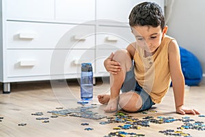 Child playing puzzles at home.