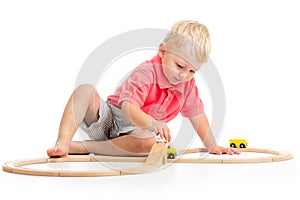 Child playing rail road toy