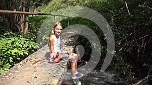 Child playing by river water, kid at camping in mountains, girl in nature