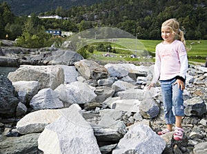 Child playing on rocks