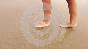 Child Playing, Running and Splashing in Slow Motion by the Beach