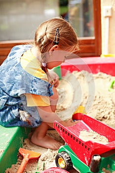 Child playing in sandbox