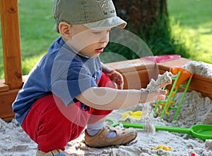 Child is playing in sandbox